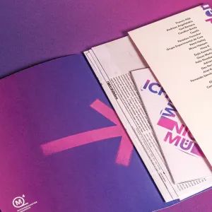 Exhibition materials with purple and pink spray paint look elements form the exhibition catalog